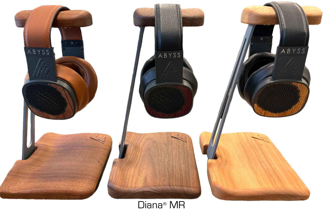 Three pairs of Abyss Diana MR headphones in different finishes hanging from wooden stands
