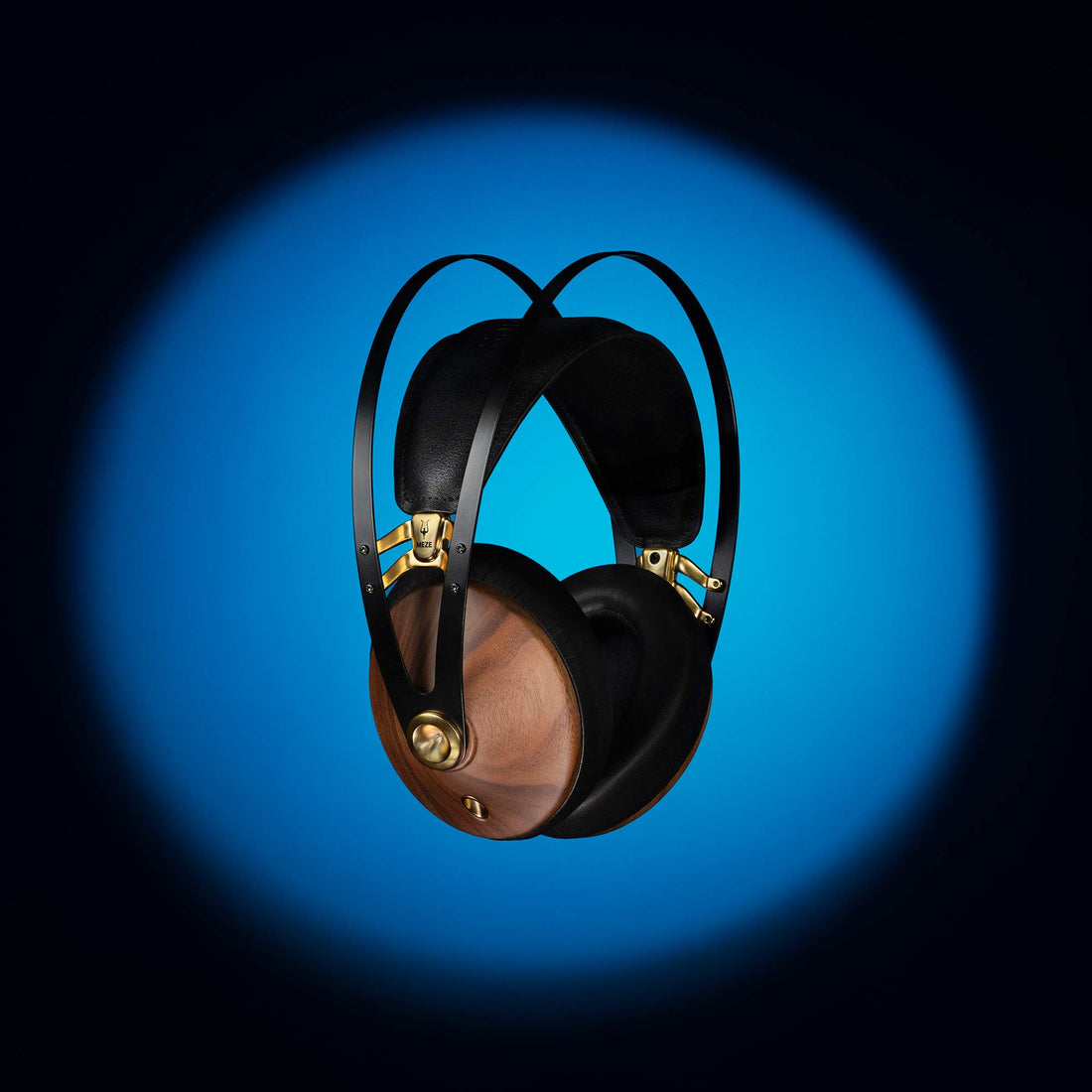 Meze 99 Classics v2 at an angle showing the wooden ear cups surrounded by a blue spotlight