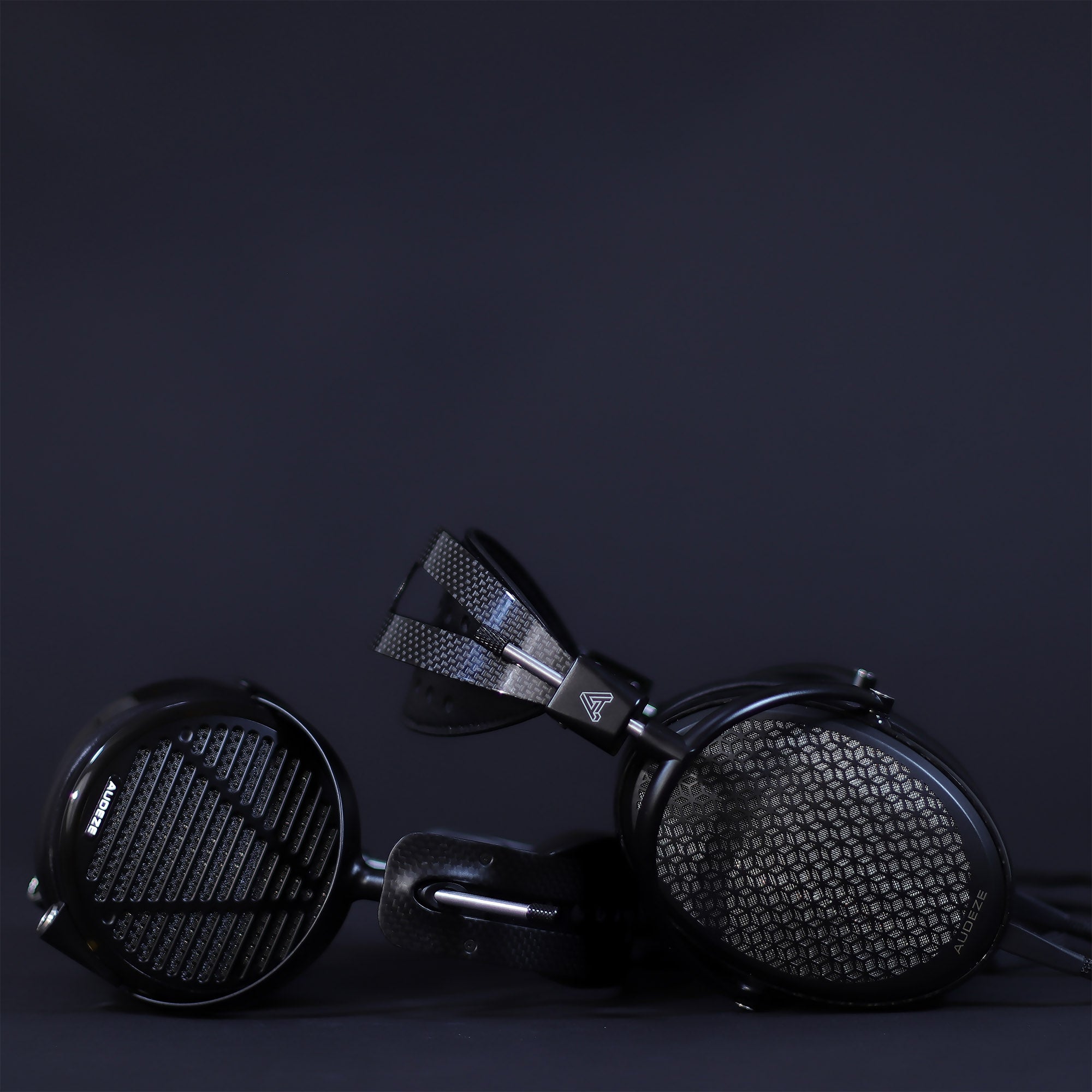 Audeze LCD-5 planar and CRBN electrostatic flagship headphones together on a black backdrop