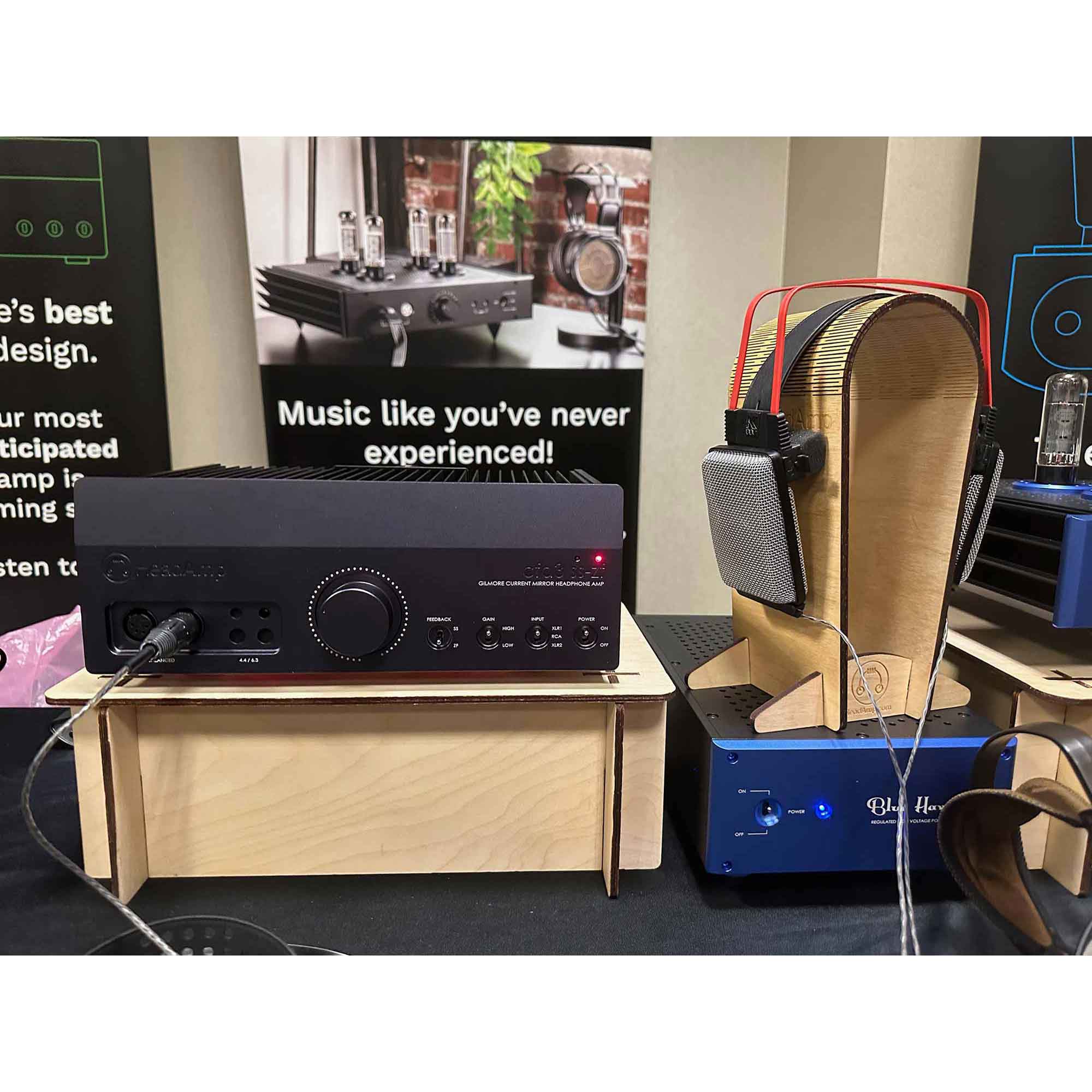 HeadAmp CFA3 headphone amp on wood riser platform with AKG K1000 ear speakers