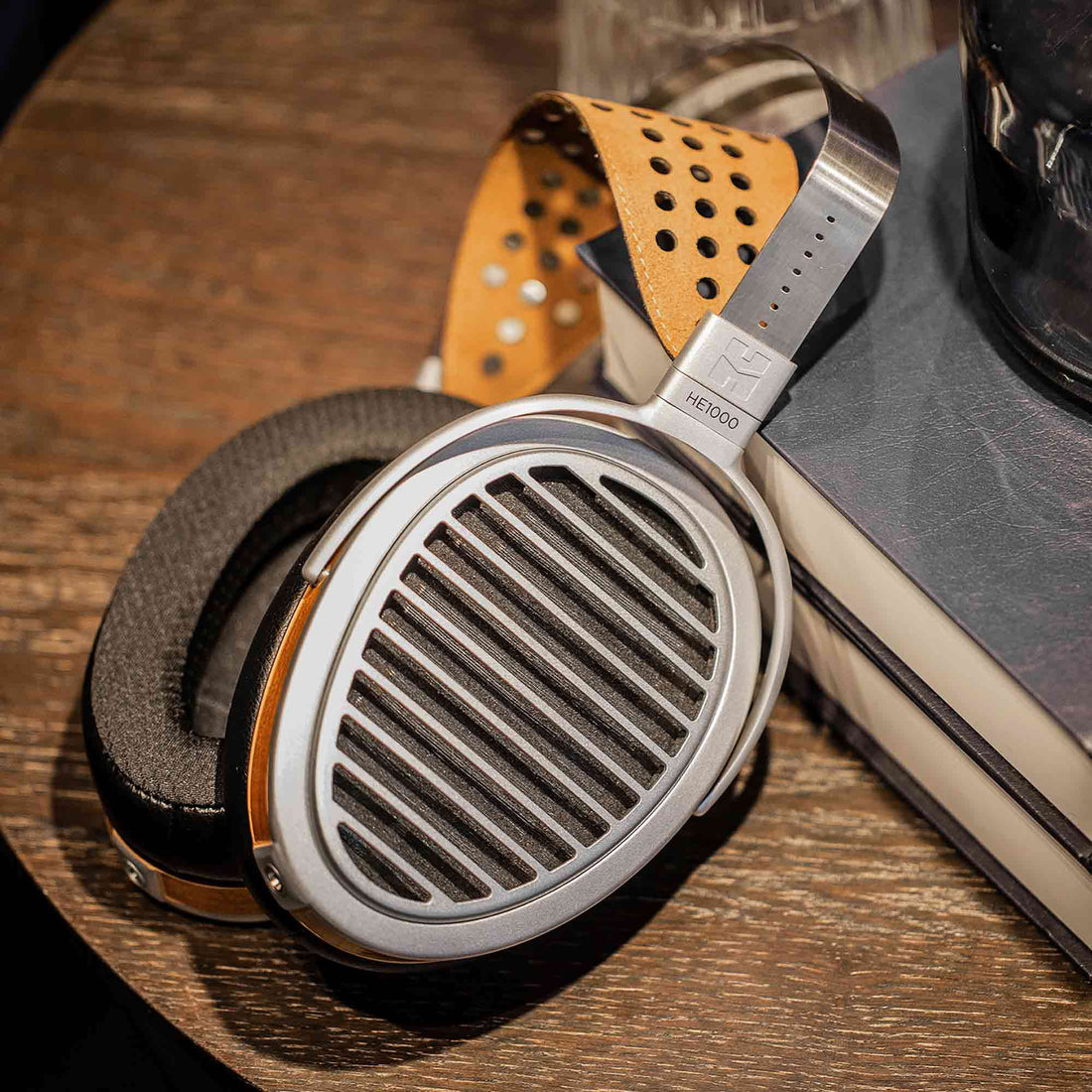 HIFIMAN HE1000 headphone lying on dark wood surface