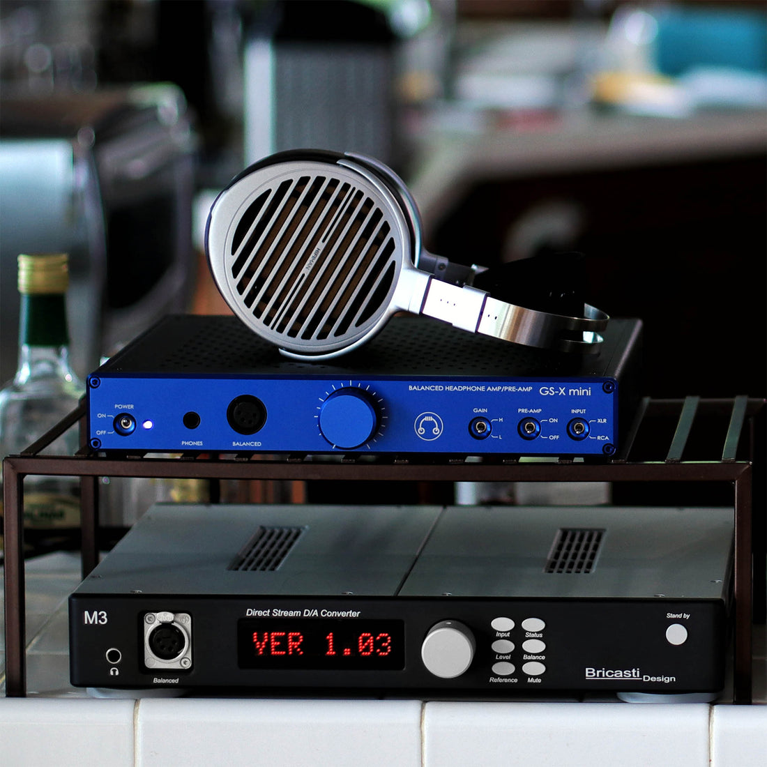 HIFIMAN Susvara on top of blue HeadAmp GS-X mini amplifier with Bricasti M3 DAC
