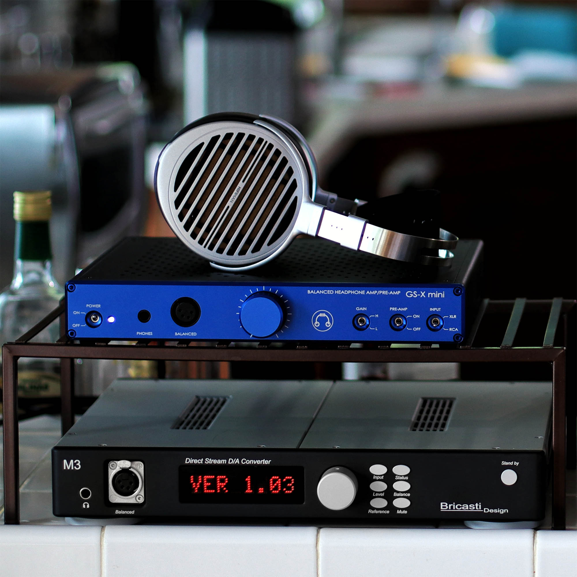 HIFIMAN Susvara on top of blue HeadAmp GS-X mini amplifier with Bricasti M3 DAC
