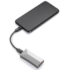 Astell&Kern AK HC4 Hi-Fi USB DAC connected to a smartphone with braided cable on white background