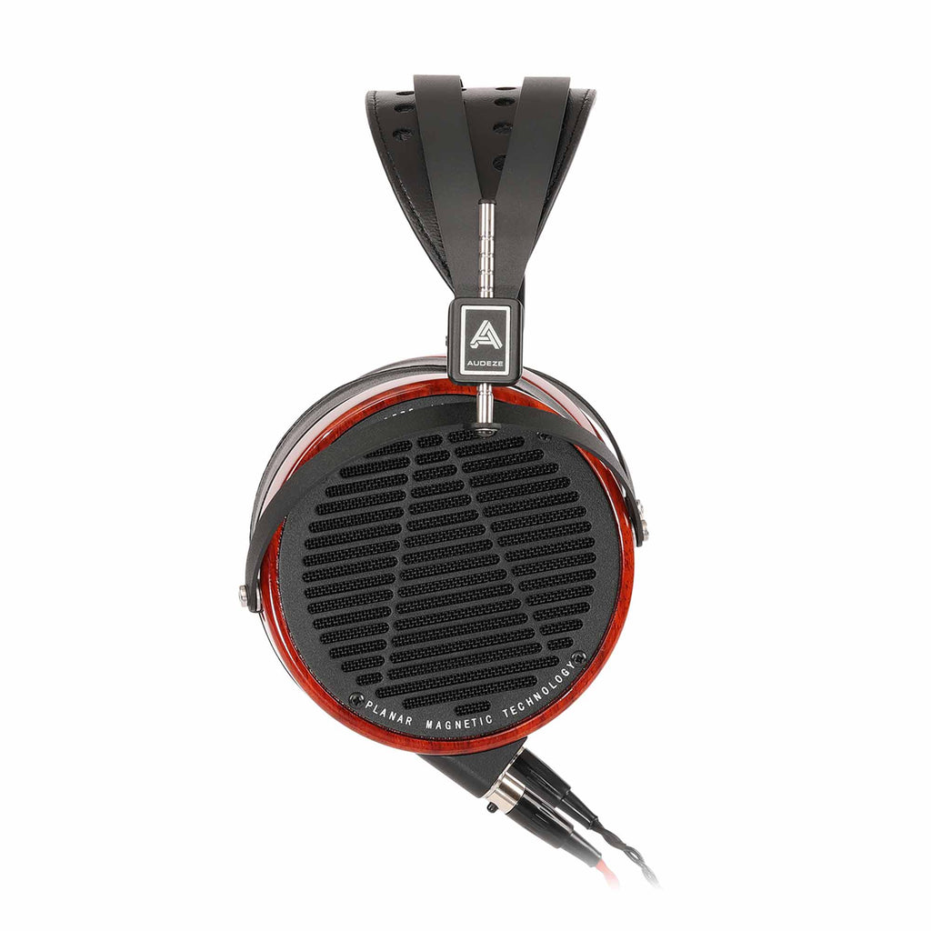 Close-up of Audeze LCD-2 • Padauk Wood planar magnetic headphone ear cup with visible grille and detachable cable