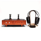 STAX SR-4070 Closed-Back Electrostatic Headphone (Pre-Owned) resting on wooden stand next to vintage tube amplifier on white background