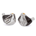 Close-up of the Campfire Astrolith Dual Planar IEM with polished metal faceplates and black shell on white background