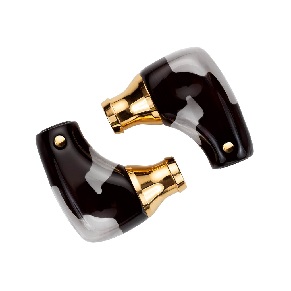 Pair of Campfire Axion IEMs with gold nozzles and black and gray marbled shells on white background