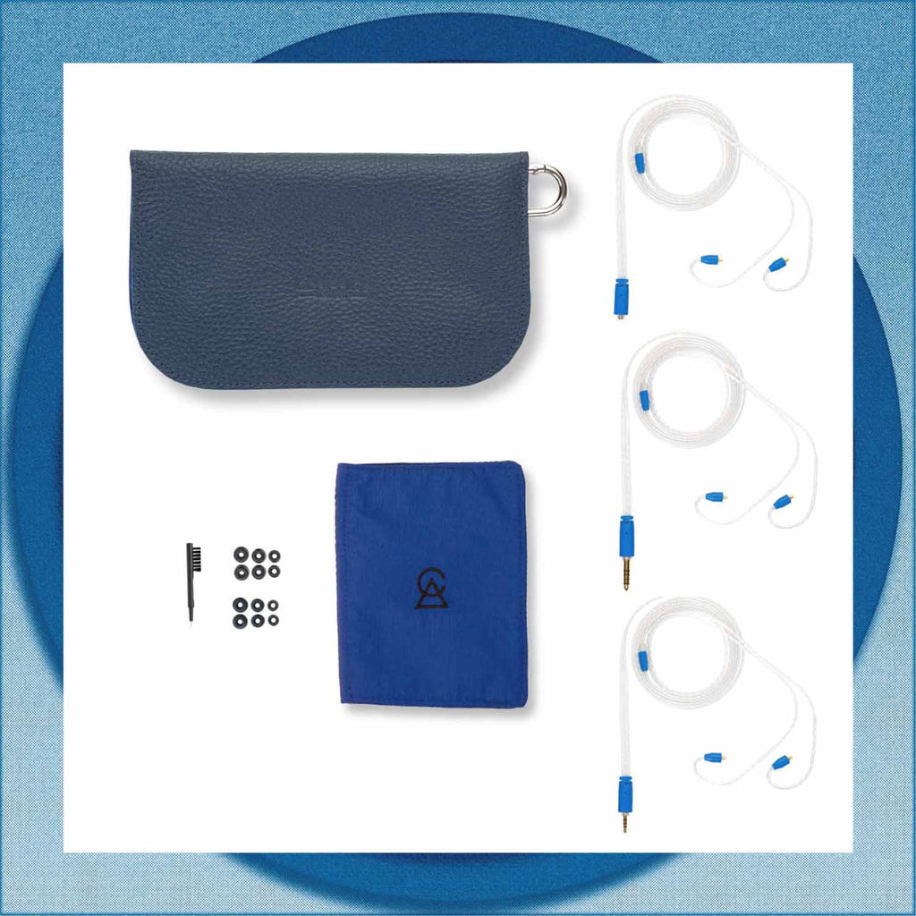 Flat lay of Campfire Cascara accessories including carrying case, blue pouch, three white cables, and ear tips on white surface