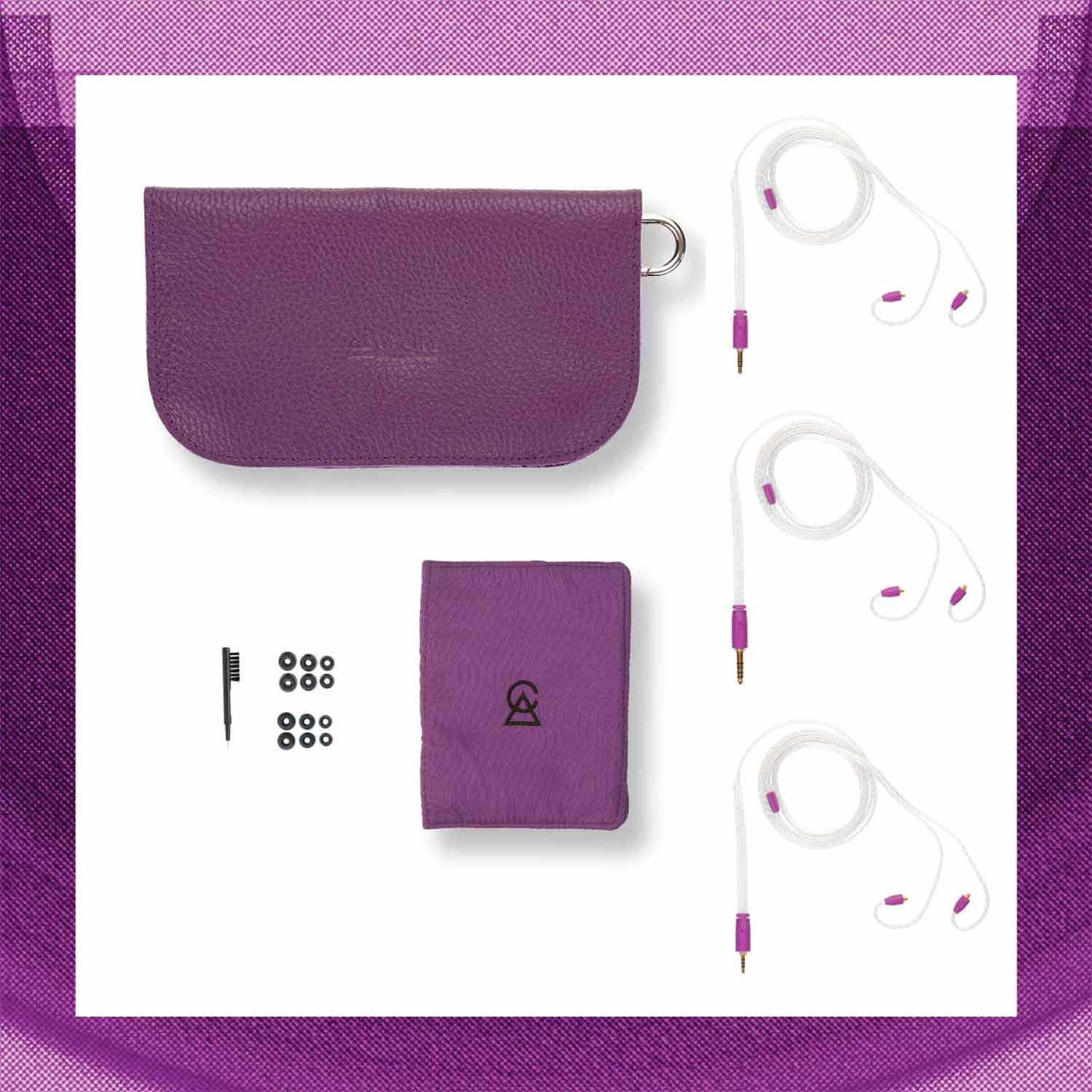 Flat lay of Campfire Bonneville earphones with purple carrying case, cleaning brush, and multiple ear tips on white background
