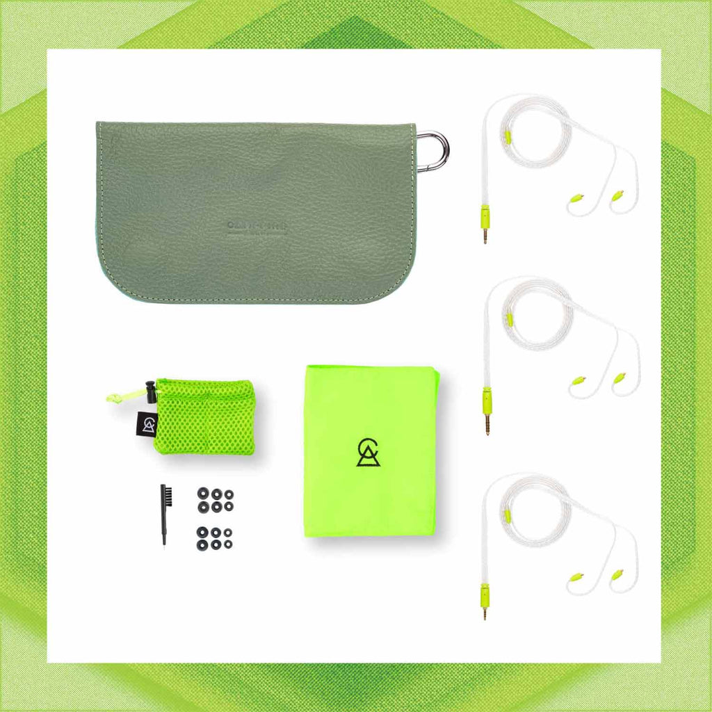 Flat lay of Campfire Ponderosa earphones with gray carrying case, lime green cloth, cleaning brush, and ear tips on white background