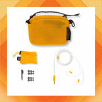 Campfire Supermoon accessories including yellow mesh carrying case, cable, ear tips, and cleaning tool on white background