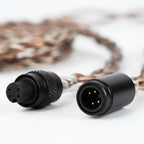 Close-up of Campfire Time Link Interchangeable IEM Cable connectors with braided copper and silver-plated wire on white background