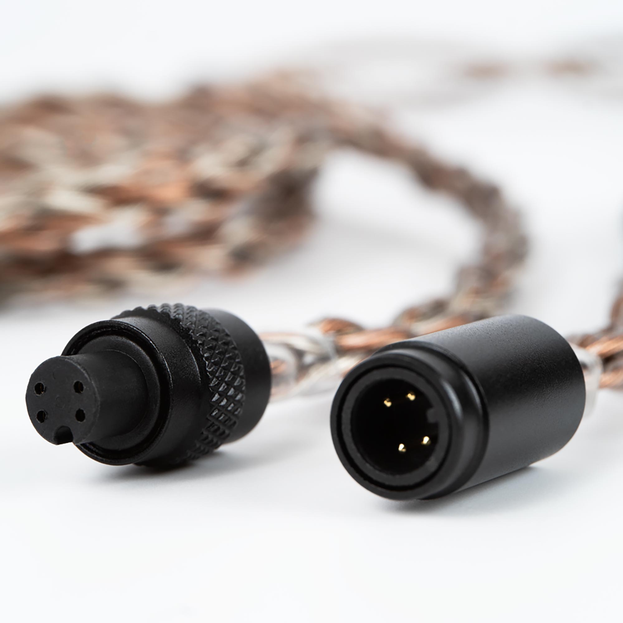 Close-up of Campfire Time Link Interchangeable IEM Cable connectors with braided copper and silver-plated wire on white background
