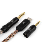 Close-up of Campfire Time Link Interchangeable IEM Cable with gold connectors and USB-C adapter on white background