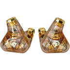 Pair of Campfire Trifecta 'Amber Radiance' - Flagship IEMs with transparent amber shells and gold accents shown side by side