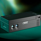 Close-up of the black Chord Suzi Modular Stereo Power Amplifier with illuminated buttons on a green gradient background