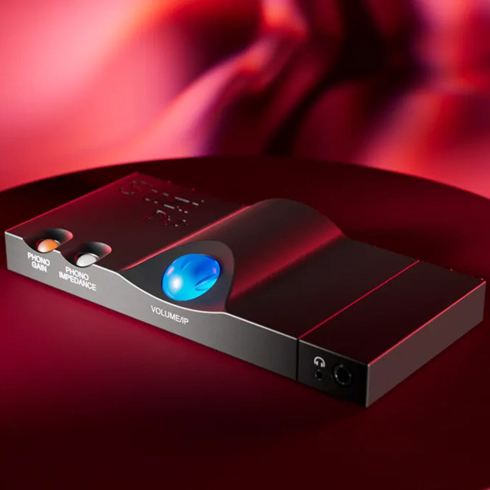 Chord Suzi Pre | Phono Preamplifier and Headphone Amp angled view with illuminated blue volume knob on red surface