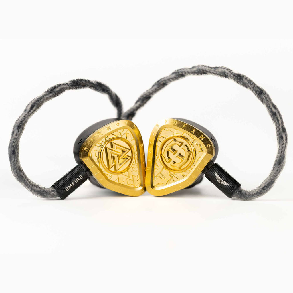 Empire Ears Odin MKII Flagship In-Ear Monitor with gold faceplates and braided black cable on white background