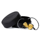 Empire Ears Odin MKII Flagship In-Ear Monitor with gold faceplates and braided cable beside black round carrying case on white background