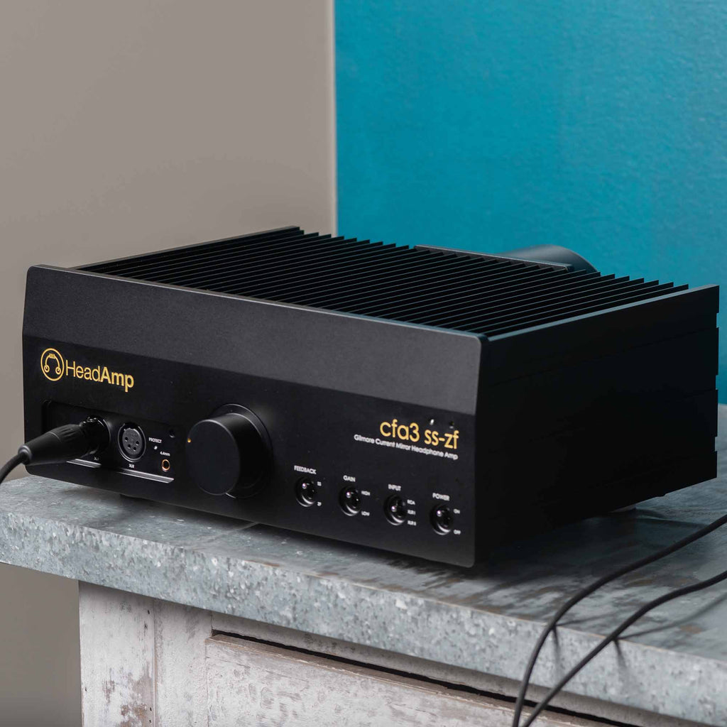 HeadAmp CFA3 Headphone Amp (Pre-Order Deposit) in black with control knobs and connected cables on a stone surface