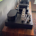 HeadAmp Grand Cayman DHT Electrostatic Amp (Pre-Order Deposit) showing vacuum tubes on matte black chassis on wooden surface