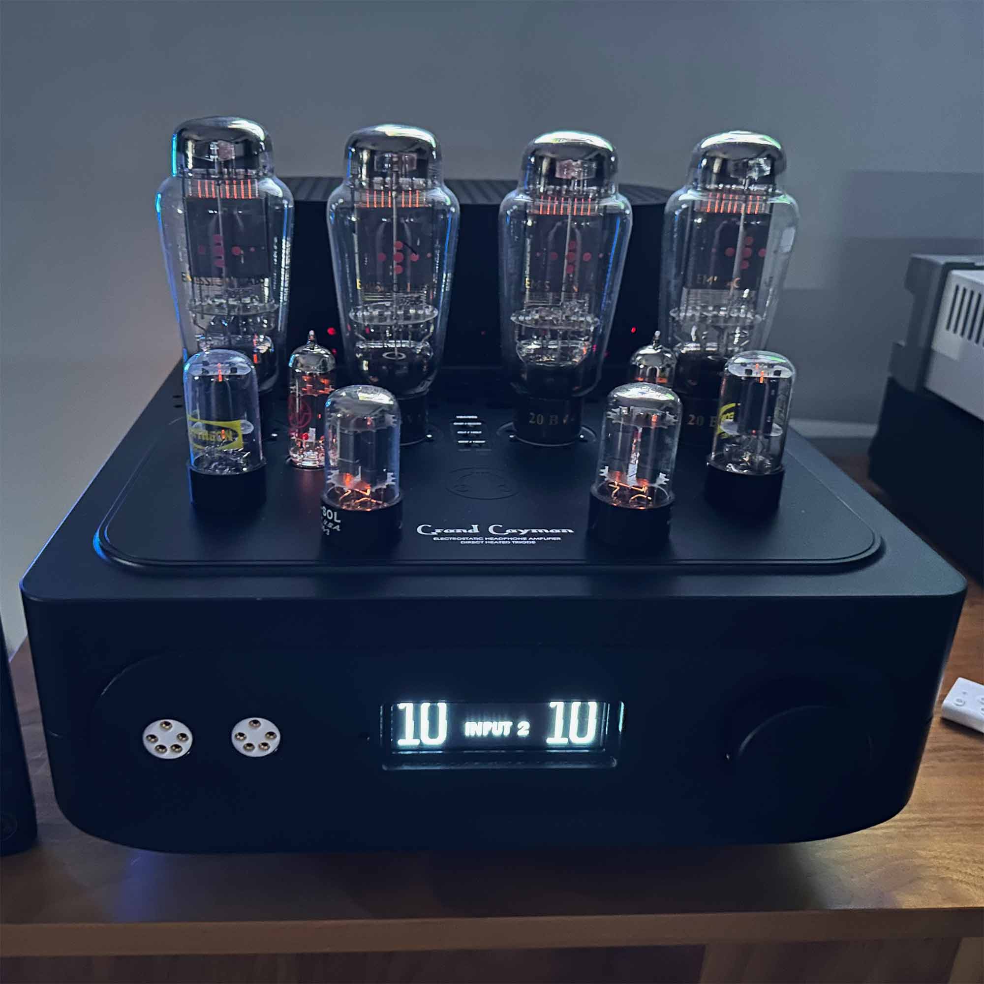 HeadAmp Grand Cayman DHT Electrostatic Amp Pre-Order Deposit showing glowing vacuum tubes and digital input display on black chassis