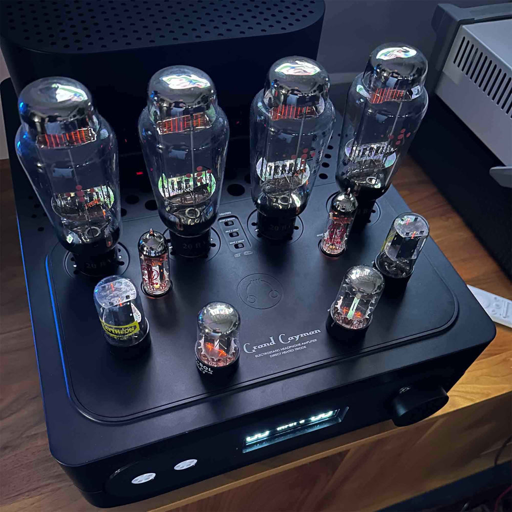 HeadAmp Grand Cayman DHT Electrostatic Amp (Pre-Order Deposit) with glowing vacuum tubes on black chassis close-up view