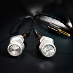 Close-up of iBasso 3T-154 Audiophile In-Ear Monitor with silver housings and braided cable on black surface