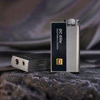 iBasso DC-Elite Flagship USB DAC/Amp with dual headphone jacks and textured metal body on dark fabric surface