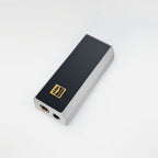 The iBasso DC04Ultra USB DAC/Amp is a rectangular device by iBasso featuring a black top, brushed silver sides, USB-C connectivity, standard and 4.4mm Balanced ports, and a gold Hi-Res AUDIO label on top. Background is plain white.