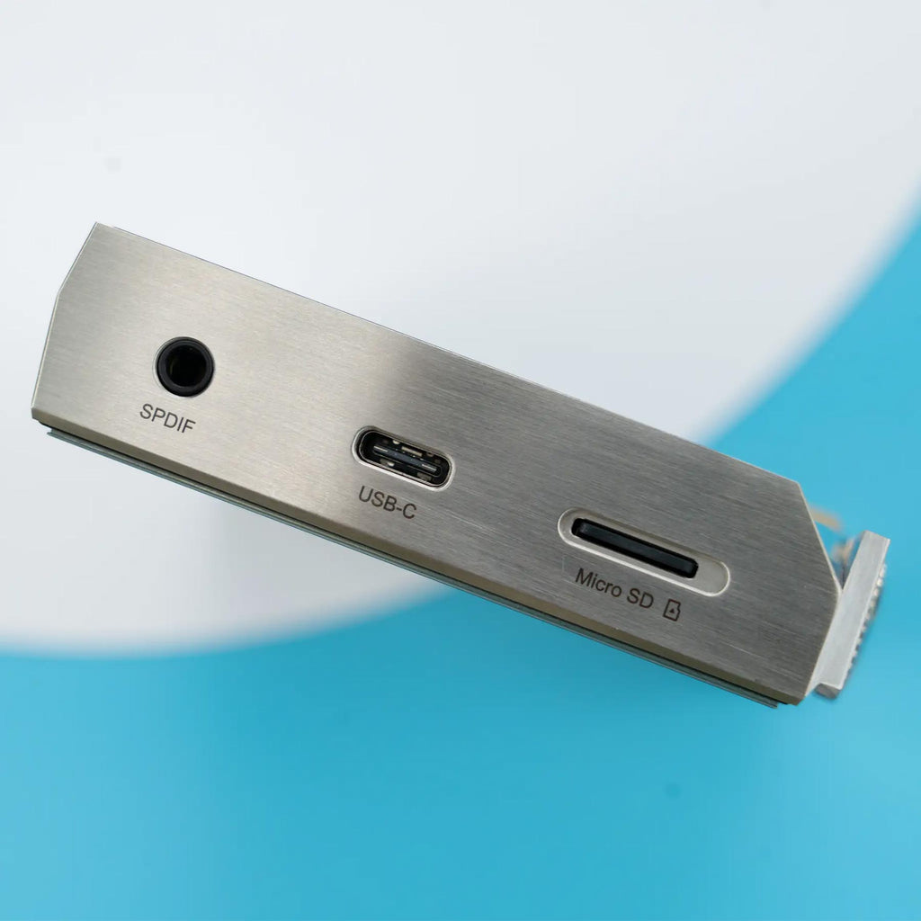 Close-up of iBasso DX340 Flagship Digital Audio Player module showing SPDIF, USB-C, and Micro SD card slots on metal panel