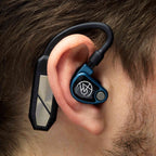 Close-up of iFi Audio GO Pod Wearable Bluetooth DAC/Amp attached behind the ear with in-ear monitor on person