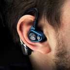 Close-up of iFi Audio GO Pod Wearable Bluetooth DAC/Amp fitted in ear with black ear hook on dark background