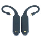 Pair of black iFi Audio GO Pod Wearable Bluetooth DAC/Amps with gold pins and flexible ear hooks on white background
