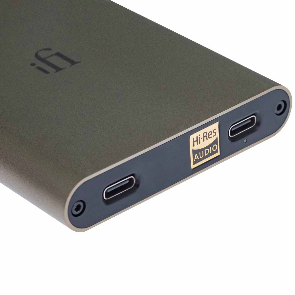 Close-up of iFi Audio hip-dac3 Portable USB DAC/Amp showing USB-C ports and Hi-Res Audio logo on titanium body