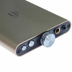Close-up of the iFi Audio hip-dac3 Portable USB DAC/Amp with volume knob and headphone jacks in titanium shadow finish