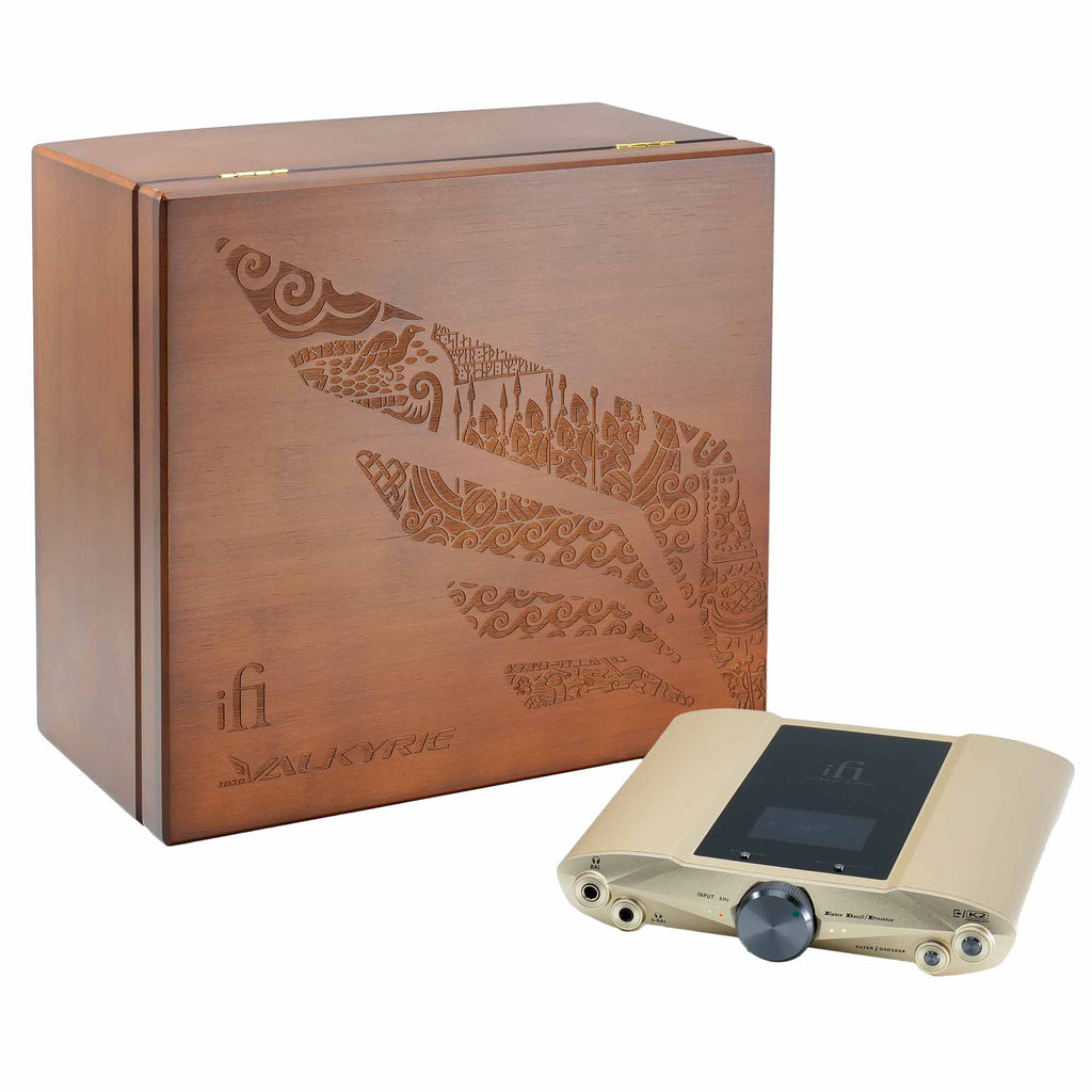 iFi Audio iDSD Valkyrie DAC and Headphone Amp with gold finish next to a wooden storage box with intricate design