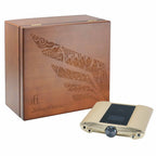 iFi Audio iDSD Valkyrie DAC and Headphone Amp with gold finish next to a wooden storage box with intricate design