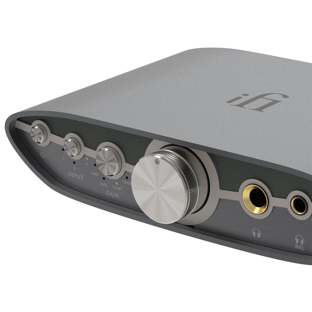 Close-up of iFi Audio ZEN CAN 3 Balanced Headphone Amp with control knobs and headphone jacks on gray casing