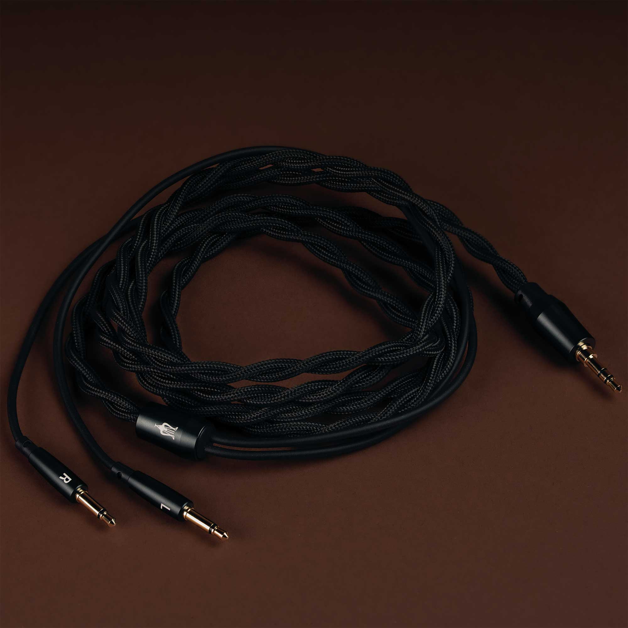 Detachable twisted audio cable with gold connectors for Meze 105 SILVA Dynamic Open-Back Headphones on brown background