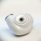 Close-up of silver Meze ALBA In-Ear Monitors with design details and smooth finish on a light background