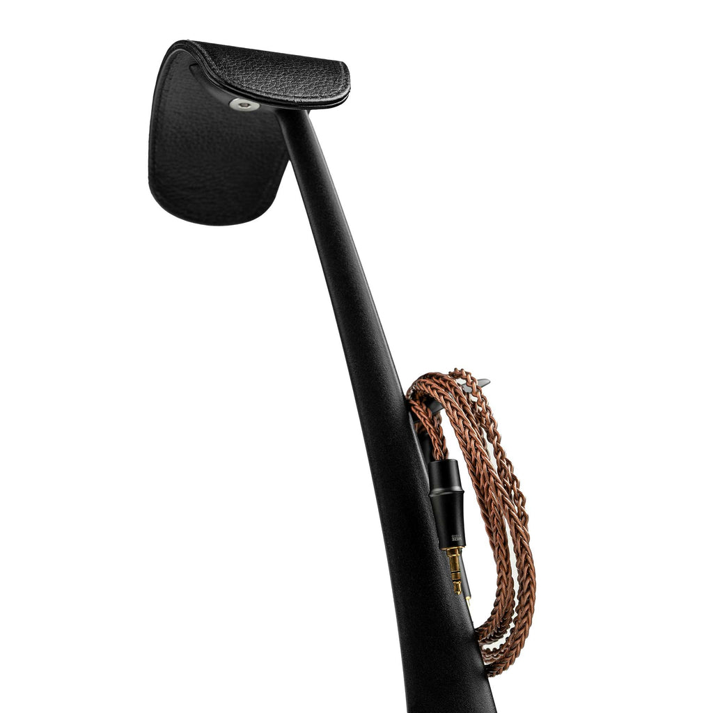 Close-up of the Meze Manta Headphone Stand showing the retractable cable hanger with braided cable wrapped around it