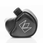 Close-up of the Noble Audio XM-1 IEM with xMEMS Driver showing sleek black design and connector threading detail
