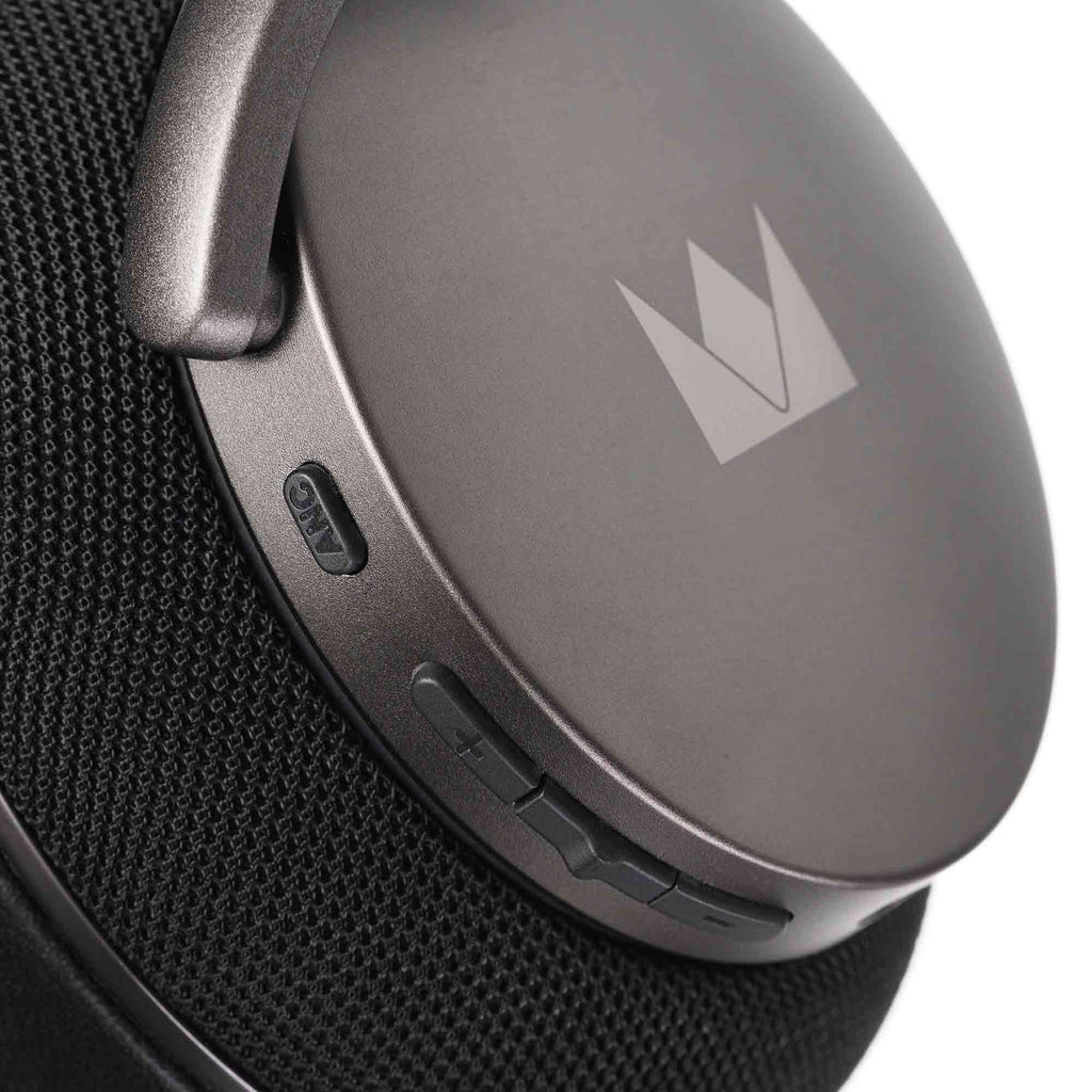 Close-up of the Noble Audio FoKus Apollo Wireless Headphones ear cup with control buttons and logo on a dark background