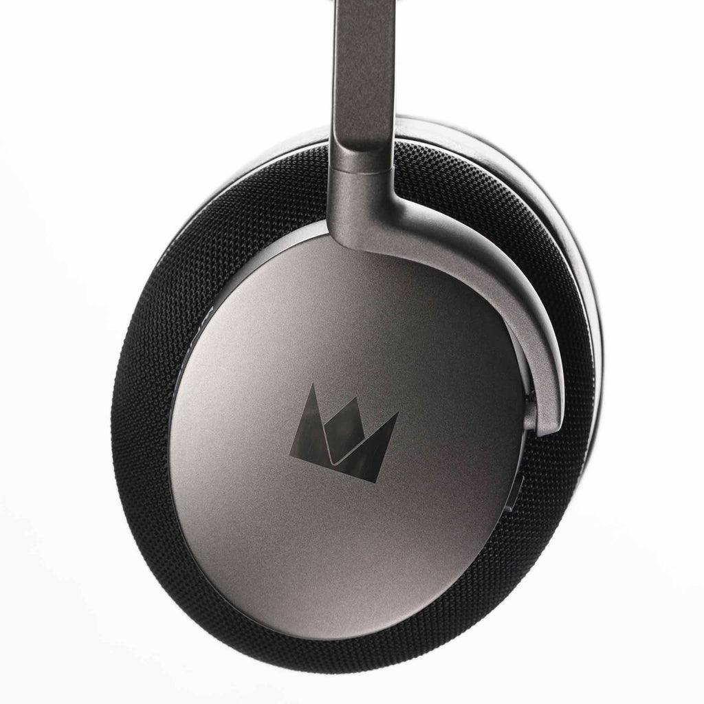 Close-up of the right ear cup of Noble Audio FoKus Apollo Wireless Headphones with metal finish and logo on white background