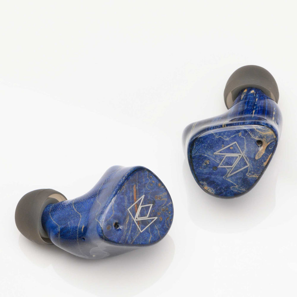 Noble Audio FoKus Prestige Wireless IEM in blue with black ear tips on a white background close-up view