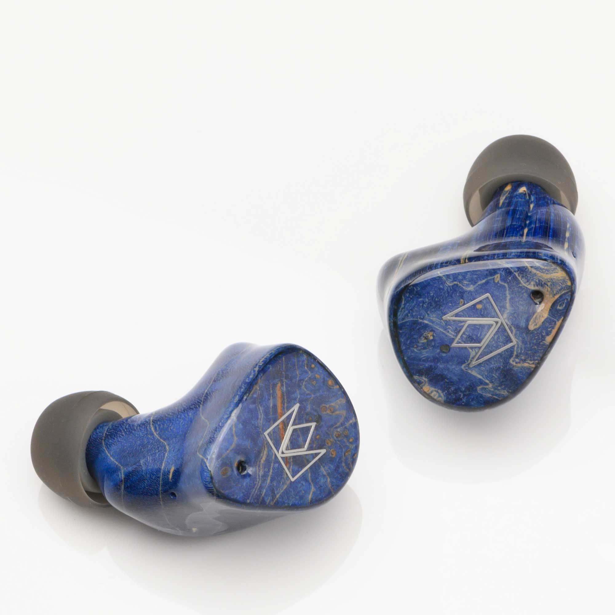 Noble Audio FoKus Prestige Wireless IEM in blue with black ear tips on a white background close-up view