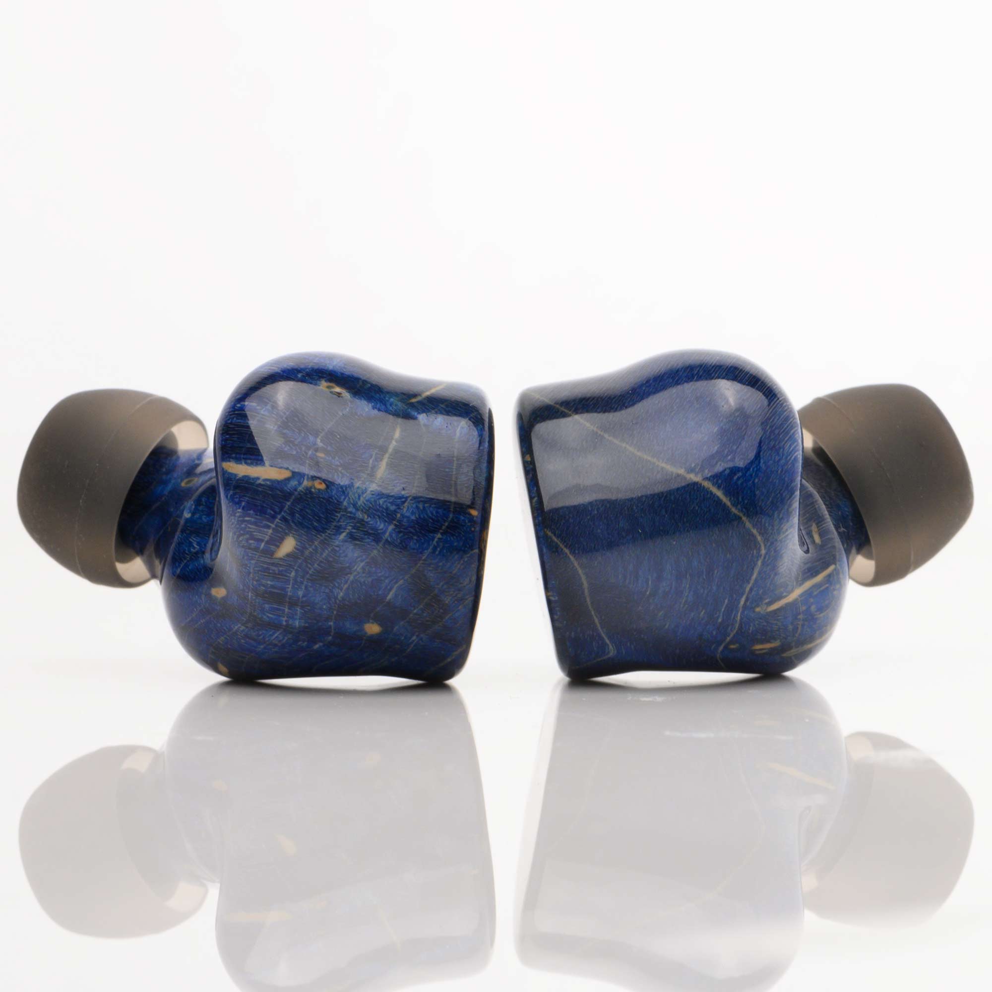 Noble Audio FoKus Prestige Wireless IEMs in deep blue with gold veining and black ear tips on white surface