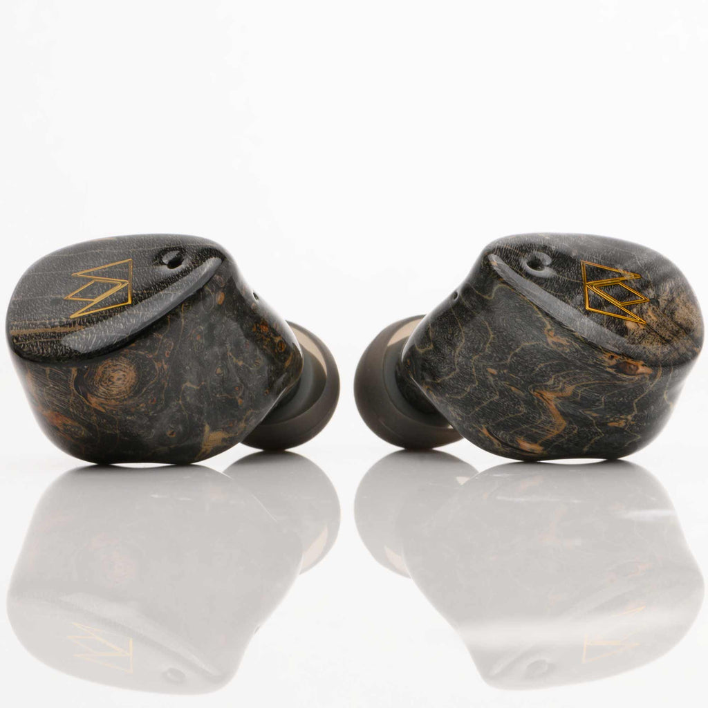 Noble Audio FoKus Prestige Wireless IEM with dark wood grain finish and gold logo on a reflective surface